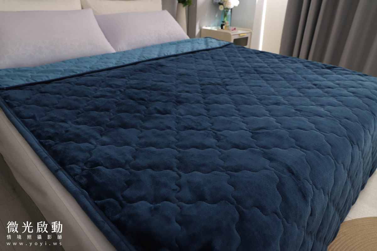 藍色絎縫毛毯特寫，立體紋理清晰可見，專業商品攝影，強調材質細節